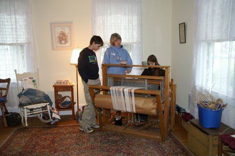 A person weaving on a loom